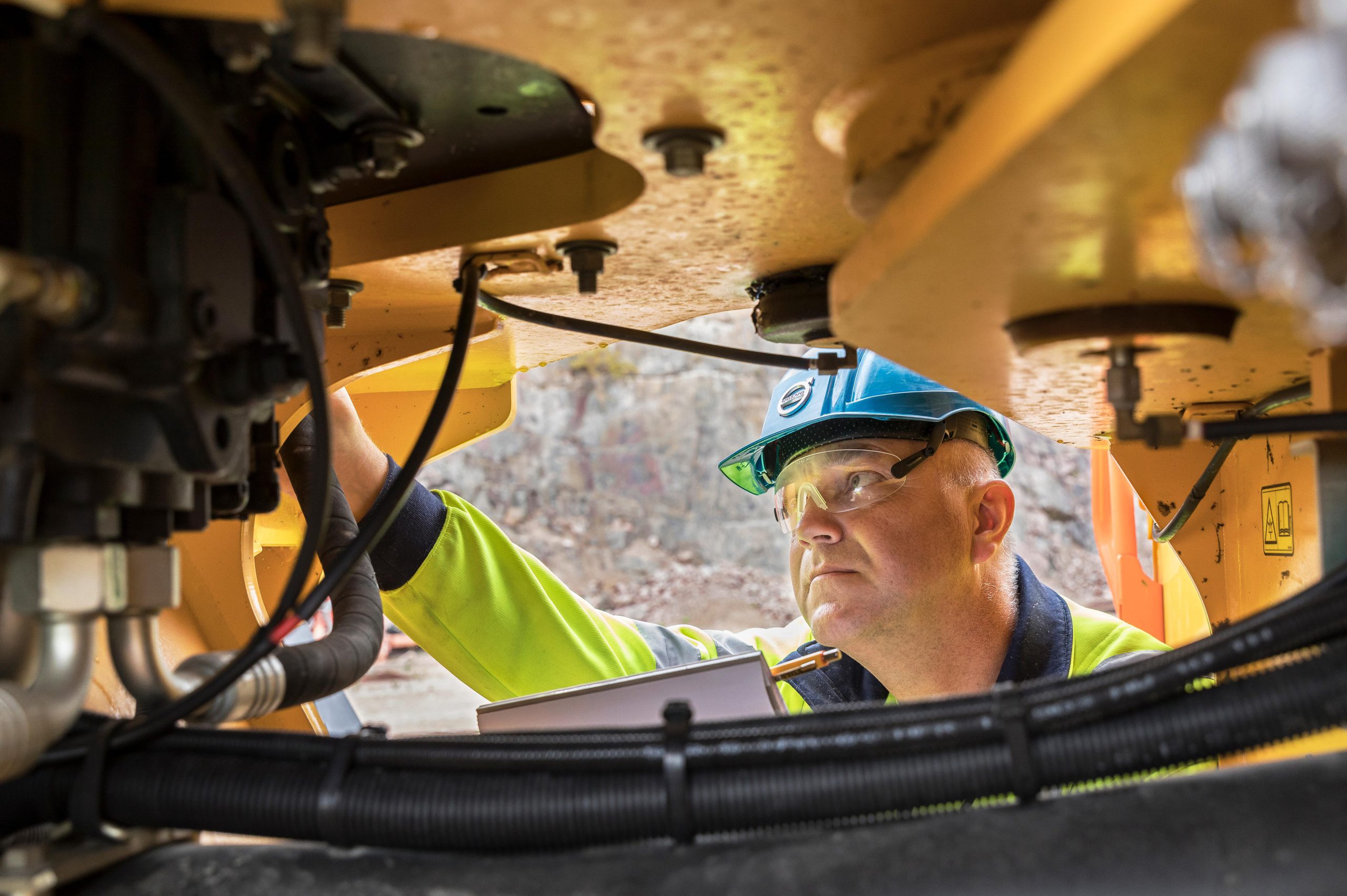 Volvo service technician inspecting a machine
